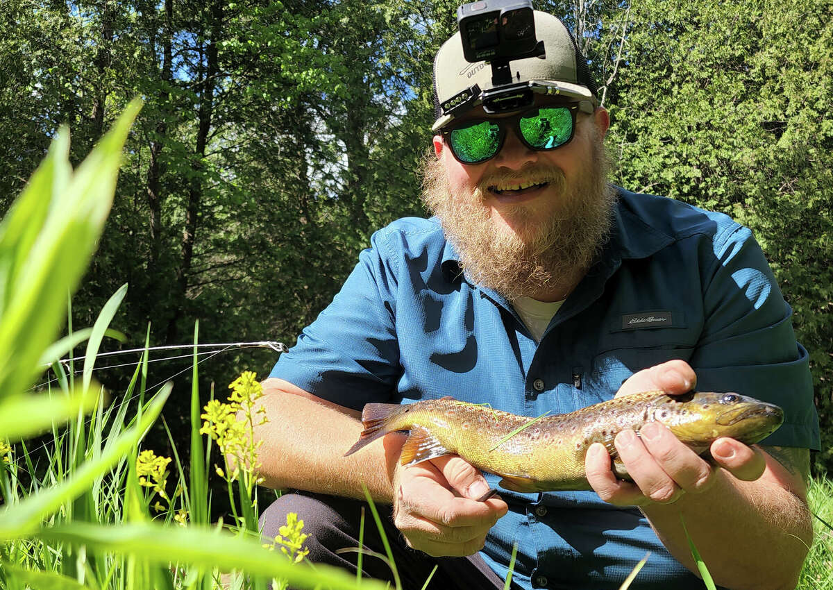Tomas Truax recently caught a brown trout on a small stretch of river in Manistee County.