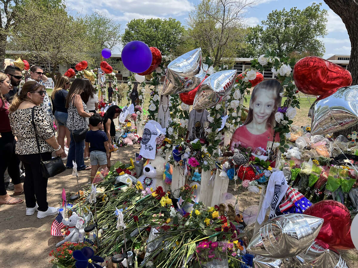A memorial outside the Uvalde elementary school features life size photos of the 19 children killed in the Texas massacre.  