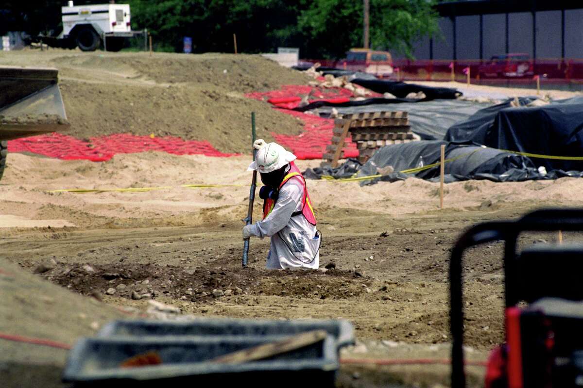 A worker digs while capping the contaminated Raymark Industries property in Stratford, Conn. in June of 1997.
