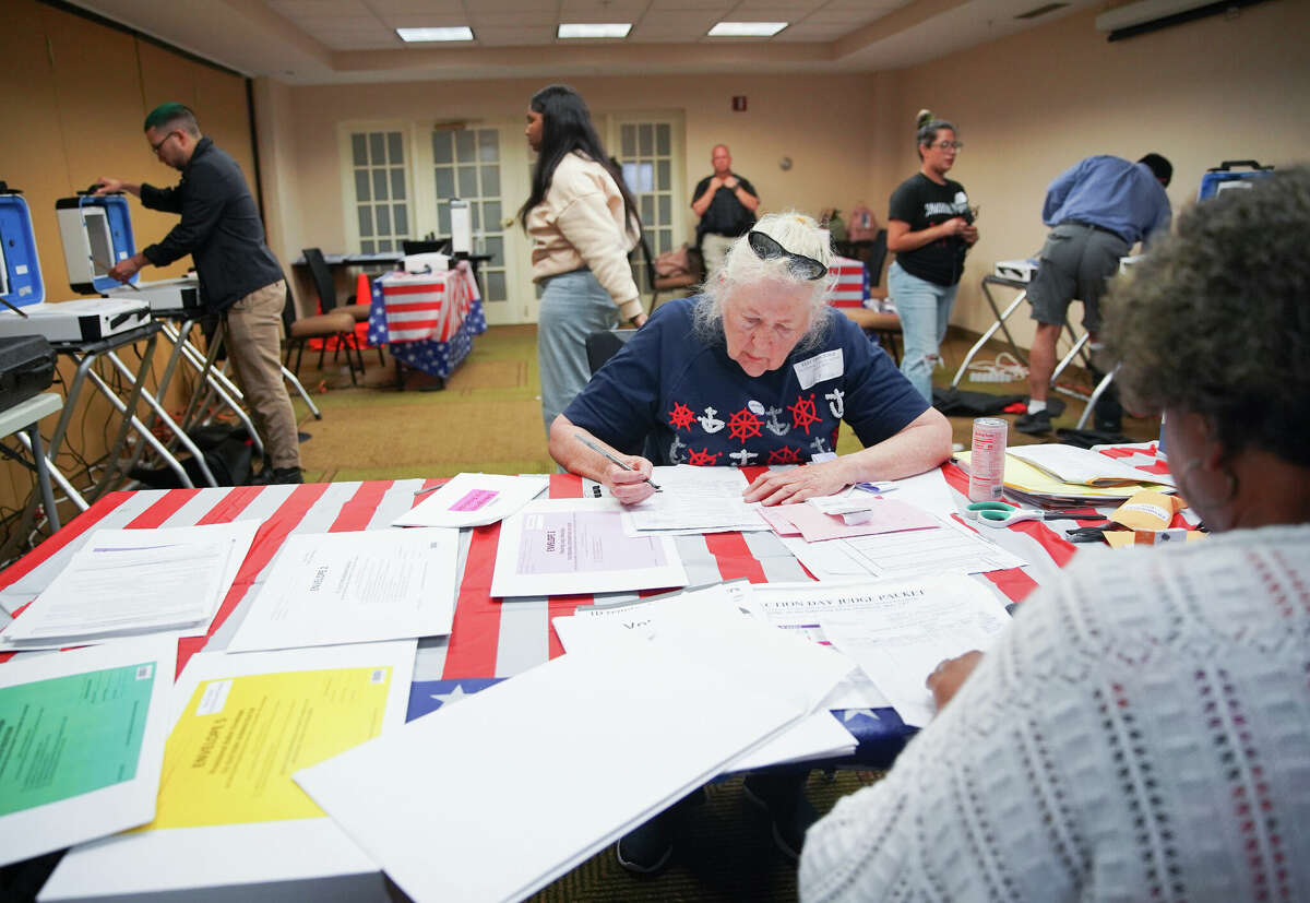 Harris County election judge Poppy Northcutt and other election workers close down a polling station at La Quinta Inn near the Galleria in Houston on Tuesday, May 24, 2022.