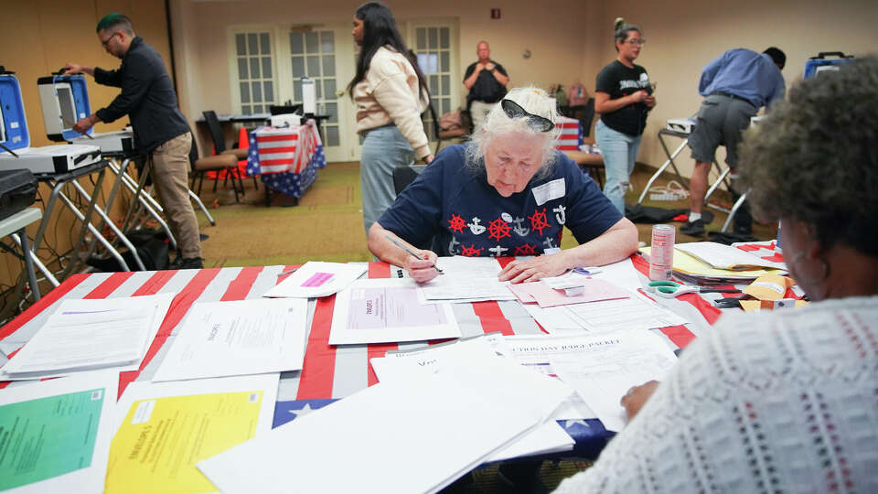 Harris County election judge Poppy Northcutt and other election workers close down a polling station at La Quinta Inn near the Galleria in Houston on Tuesday, May 24, 2022.