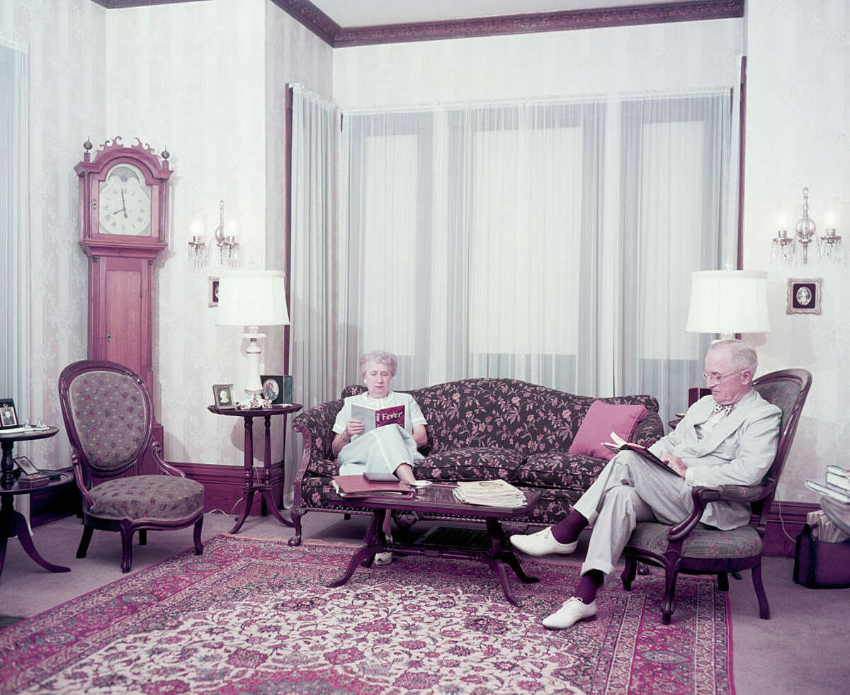 Former president Harry Truman and his wife Bess read in the living room of their home.