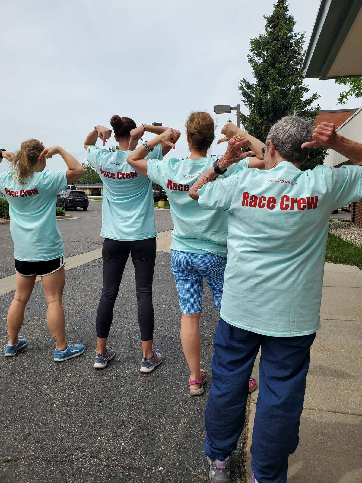 From left, Race Director Jennifer Adamcik, 50+ Program Coordinator Amanda Ewald, longtime volunteer Rita Egan and Volunteer Coordinator Kari Wedge pose for a series of photos Wednesday while preparing for the Dow Run/Walk race event, which will take place Saturday in Midland.