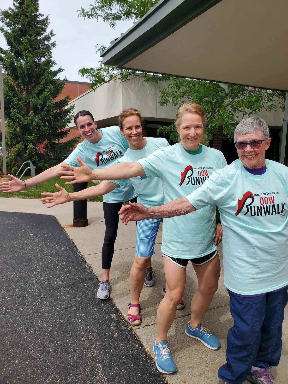 From left, Race Director Jennifer Adamcik, 50+ Program Coordinator Amanda Ewald, longtime volunteer Rita Egan and Volunteer Coordinator Kari Wedge pose for a series of photos Wednesday while preparing for the Dow Run/Walk race event, which will take place Saturday in Midland.