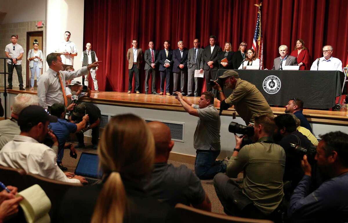 Democratic State Sen. Roland Gutierrez (left) steps forward to address Texas Gov. Greg Abbott as the governor announces a fund to help the families of the Robb Elementary shootings during a press conference in Uvalde on Friday, May 27, 2022. Gutierrez plead to the governor to call a special session to discuss gun reform. Abbott also expressed his outrage after learning the initial details of the shooting was not as accurate as he reported based on information he was provided.