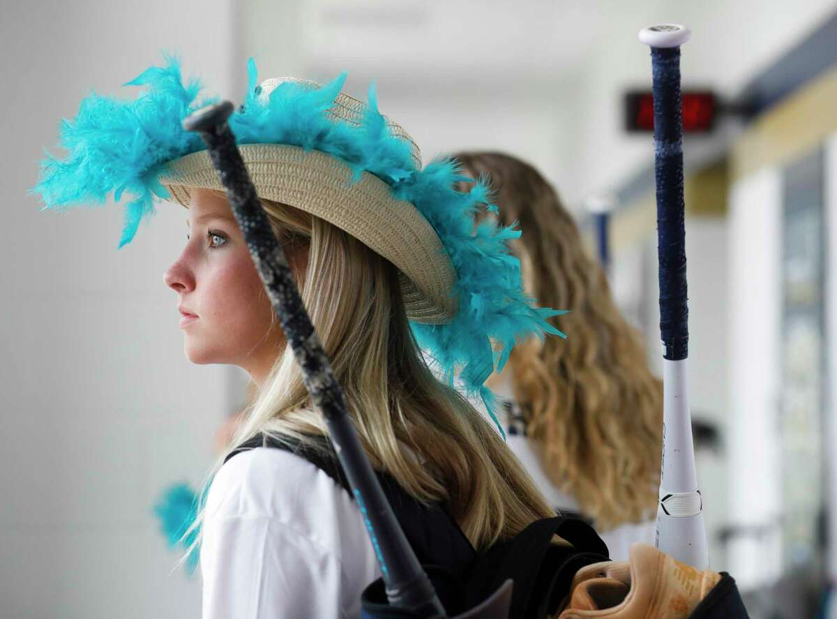 Lake Creek’s Payton Bauer wears a decorated custom cowboy hat before leaving for Austin for the program’s first trip to the UIL State Softball Championships, Thursday, June 2, 2022, in Montgomery. The Lions look to protect their undefeated 39-0 record in their Class 5A state semifinal game against Prosper Rock Hill on Friday at 10:00 a.m.
