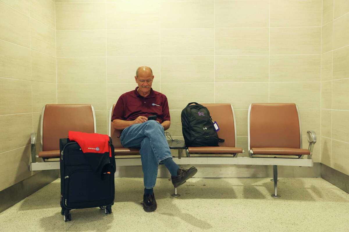 Joe Emerson of Chicago waits to catch a flight at San Antonio International Airport on May 27. Emerson is in the commercial nuclear industry.