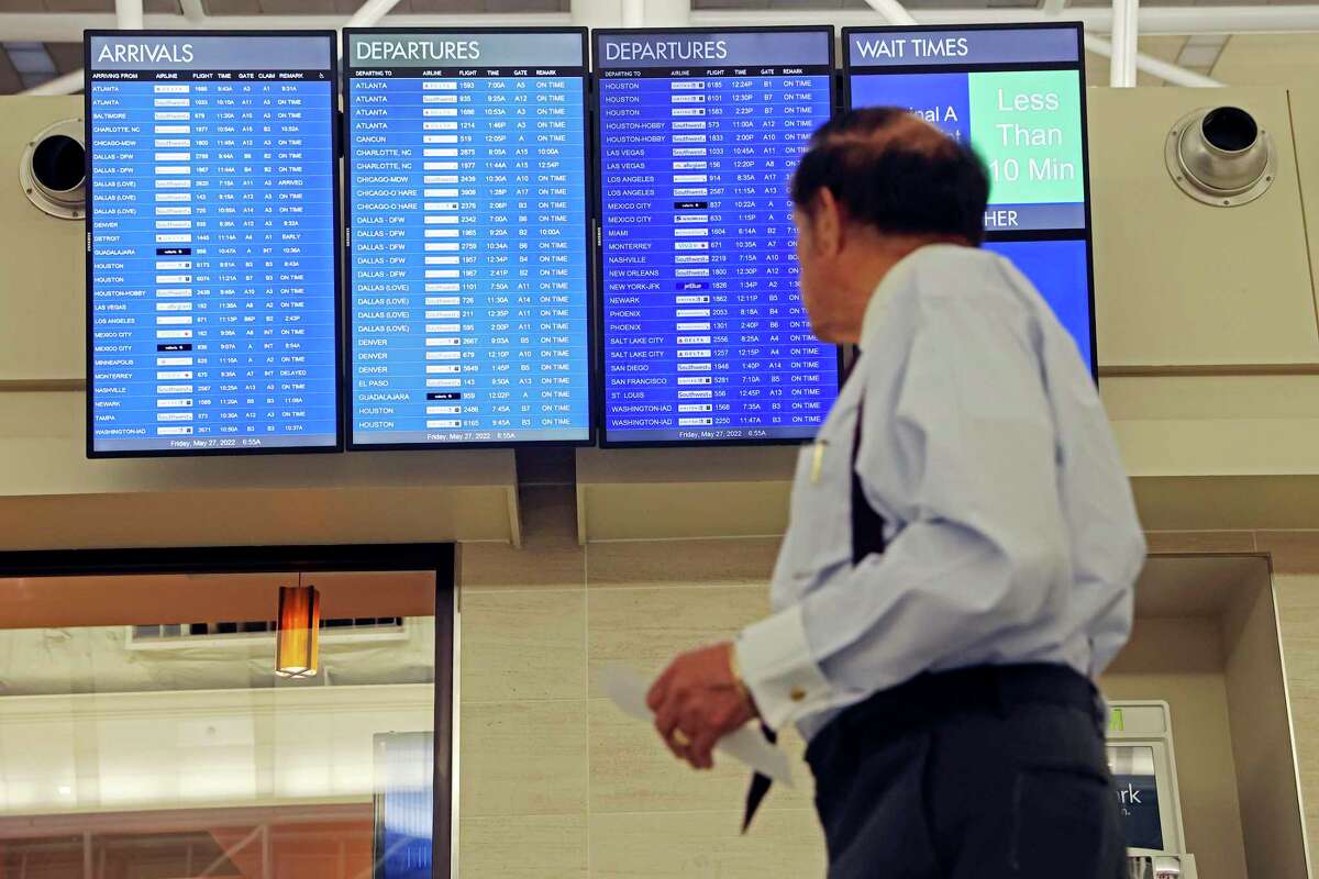 A traveler checks out a flight status board as he heads to the gates at San Antonio International Airport on May 27. Major airline executives say they’re seeing business travel rebounding, though not up to pre-pandemic levels.