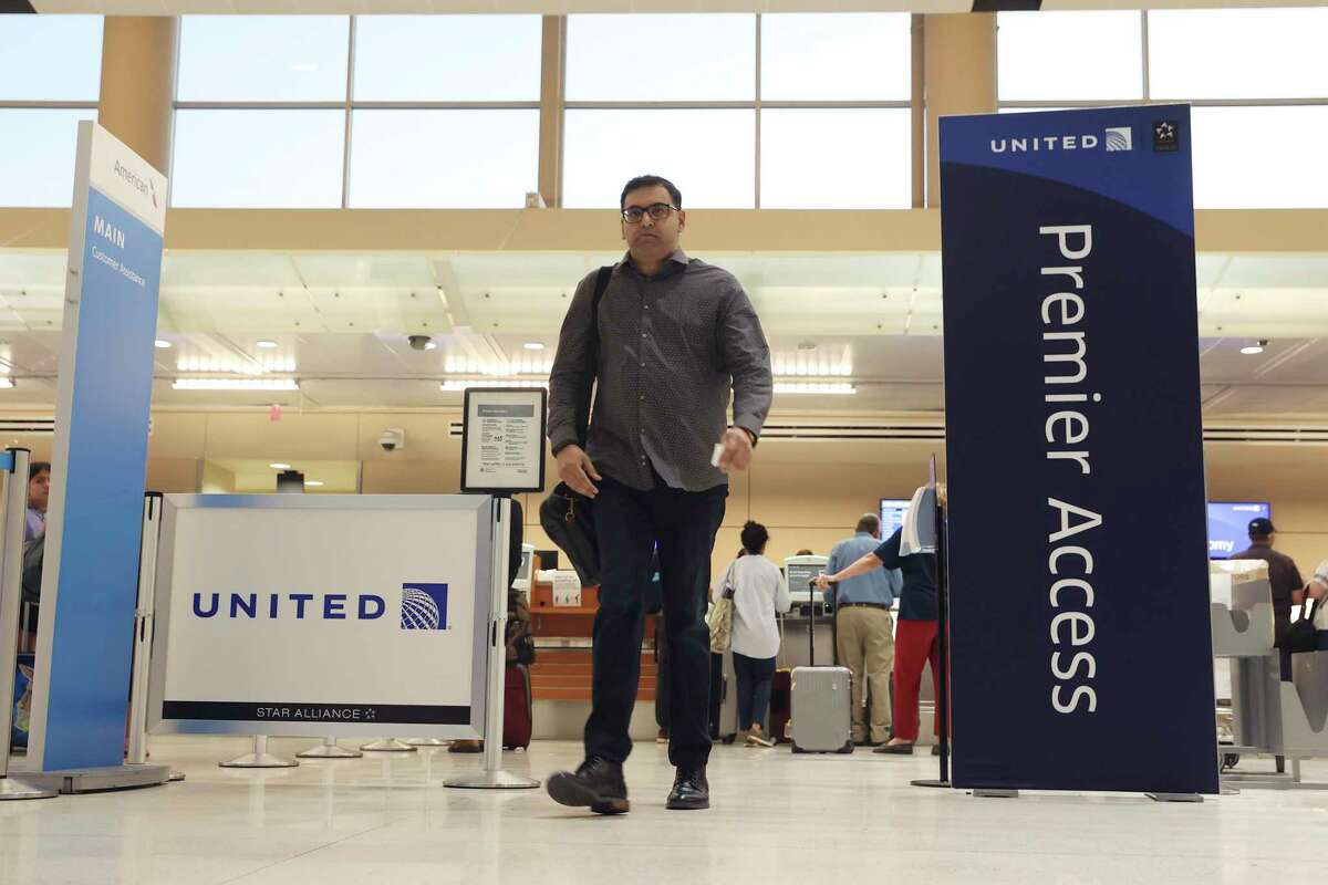 Travelers head to gates after checking in at San Antonio International Airport on May 27.
