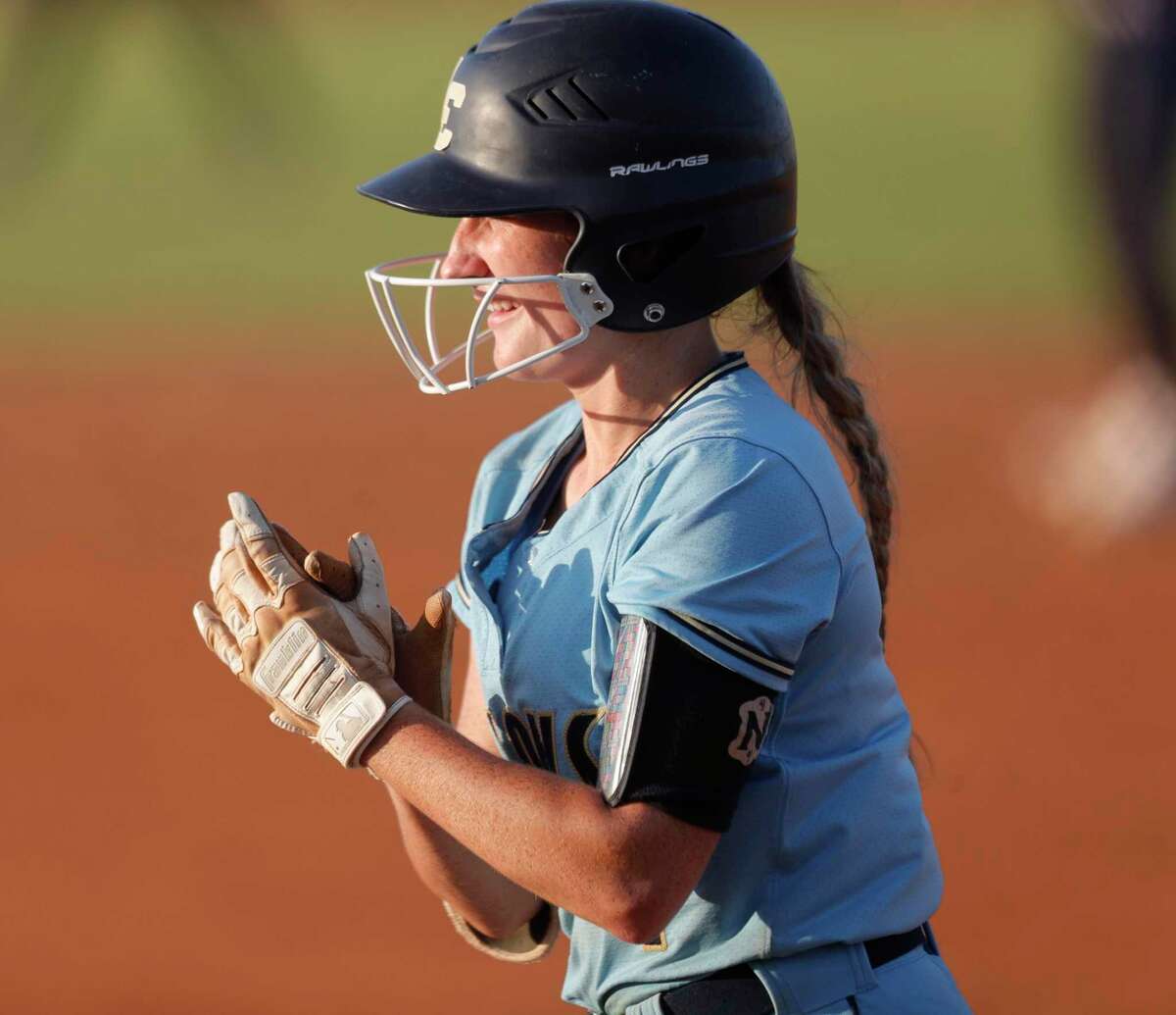 Caelee Clark #4 of Lake Creek claps after hitting a sac-RBI in the third inning of Game 1 of a Region III-5A semifinal high school softball series at Katy Tompkins High School, Wednesday, May 18, 2022, in Katy.