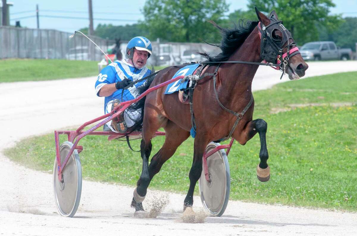 Michael Rogers, driving Loyz Singgeenesing, leads the third heat Thursday during Greene County Fair's harness races. The races had been scheduled for Wednesday evening but inclement weather pushed them to Thursday. Each 1-mile race consists of two laps of the track. Rogers won his heat. To view more photos, visit myjournalcourier.com.