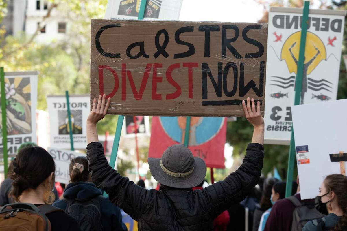 Activists march to the California State Capitol in Sacramento in October protesting contributions from the fossil fuel industry and law enforcement groups.