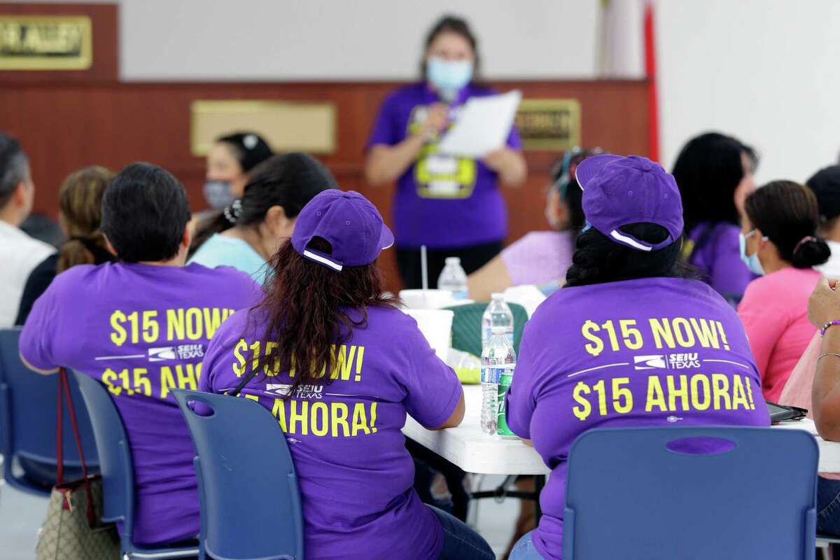 Union members wear t-shirts with their wage demands as they listen to speakers during a pre-strike meeting of the SEIU Texas membership, a Houston Janitors Union, at the IBEW Union Hall Saturday, May 28, 2022 in Houston, TX.