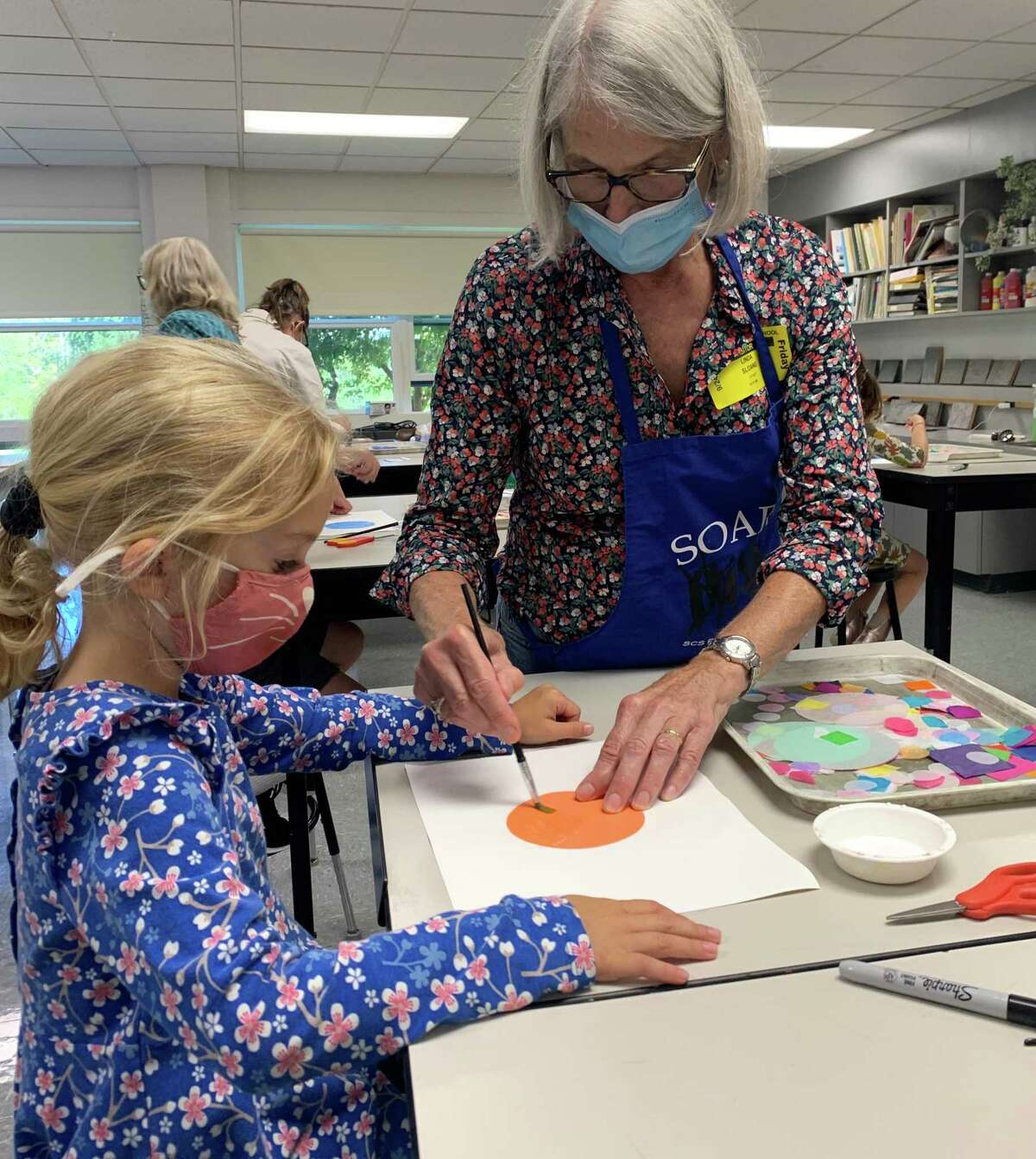 Linda Sloane, the director of SOAR Educational Enrichment, works with a Salisbury Central School student on a part of the mural.