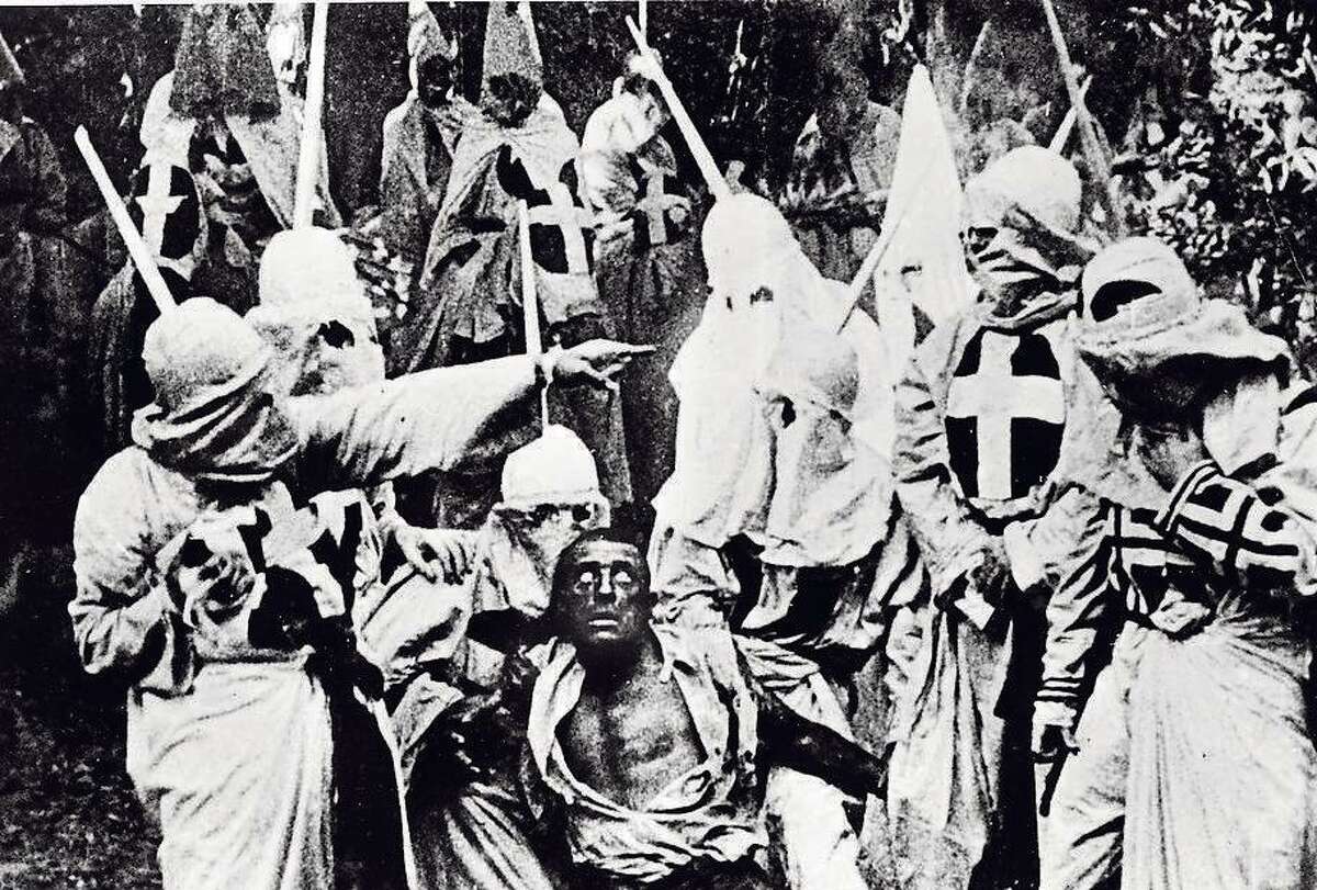Actors costumed in the full regalia of the Ku Klux Klan chase down a white actor in blackface in a still from “The Birth of a Nation,” the first feature-length film, directed by D.W. Griffith. The film inspired a wave of KKK chapter openings throughout California. While San Francisco is where the Klan gained its original foothold in the state, the hate group found a Northern California epicenter in Oakland.