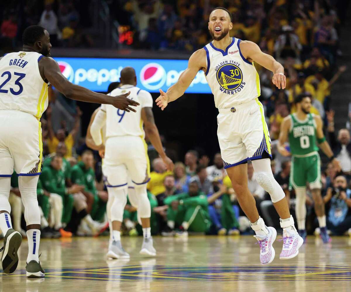 Golden State Warriors' Stephen Curry, 30, reacts after hitting a three pointer during the first quarter of the NBA Finals at Chase Center in San Francisco, Calif., on Thursday, June 2, 2022.