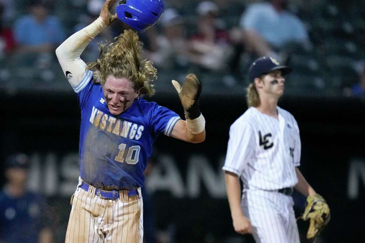 Friendswood’s Ayden Pearcy (10) reacts after scoring a run during the sixth inning of Game 2 of the Region III-5A Championship high school baseball playoff series against Lake Creek, Thursday, June 2, 2022, in Houston.