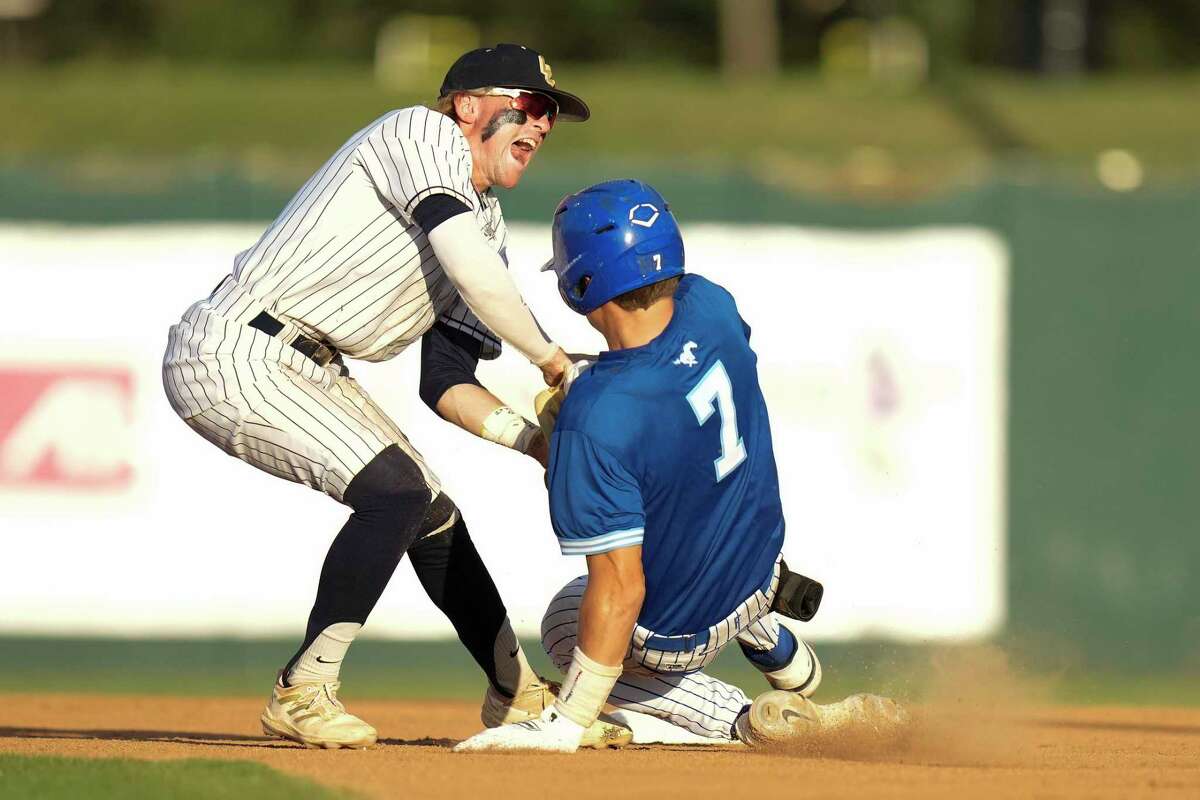 Friendswood’s Collin Goolsby, right, is tagged out by Lake Creek second baseman Jaron Lynesss during the second inning of Game 2 of the Region III-5A Championship high school baseball playoff series, Thursday, June 2, 2022, in Houston.
