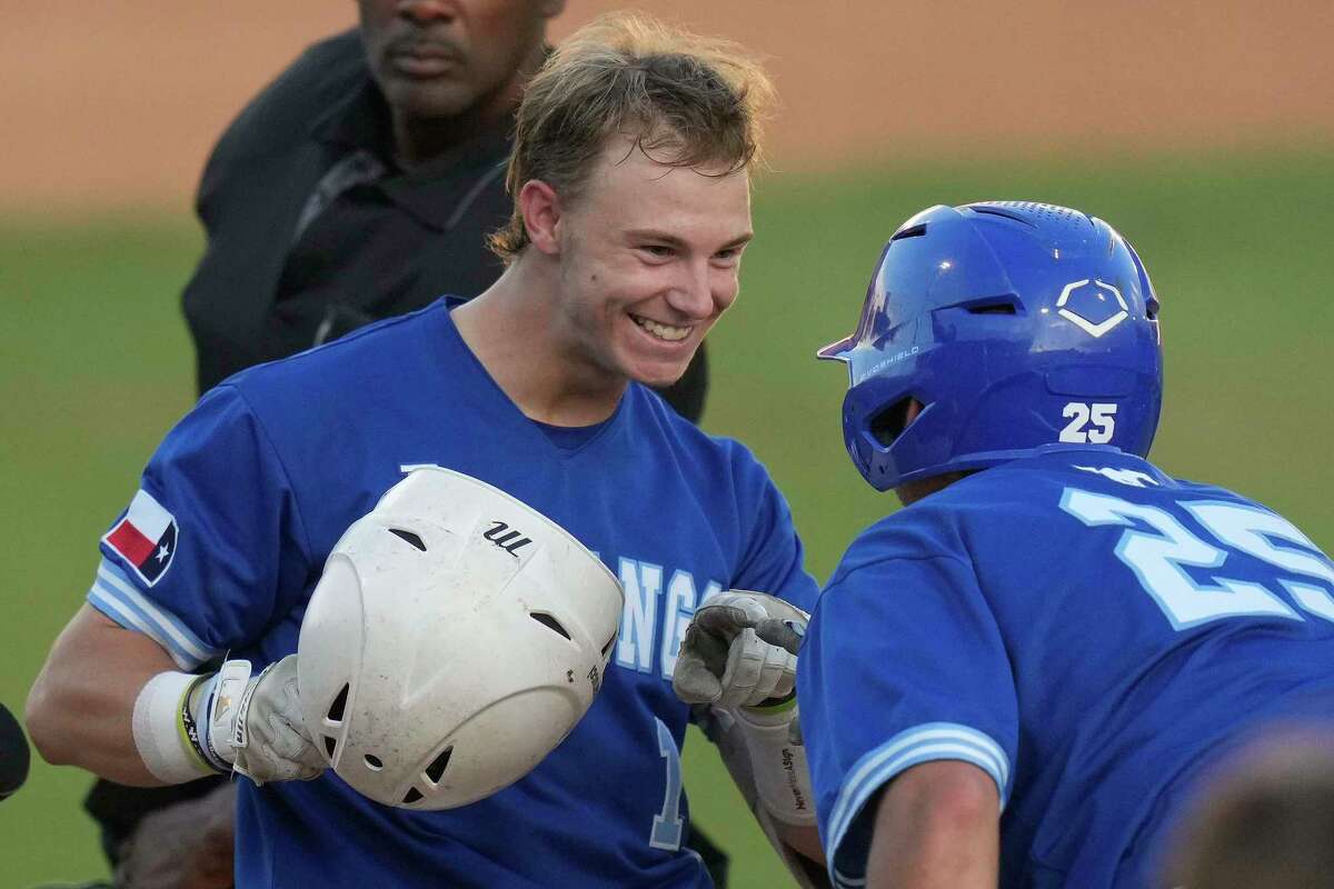 Friendswood’s Dylan Maxcey, left, celebrates his three-run home run with Boots Landry (25) during the fourth inning of Game 2 of the Region III-5A Championship high school baseball playoff series against Lake Creek, Thursday, June 2, 2022, in Houston.