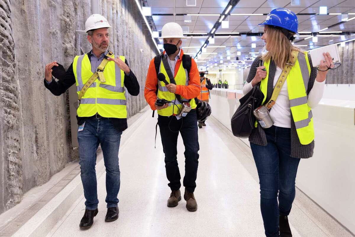 San Francisco Chronicle reporters Peter Hartlaub (center) and Heather Knight interview San Francisco Municipal Transit Agency’s Director of Transportation Jeffrey Tumlin during a tour of the newly-constructed Central Subway MUNI station at Union Square in Thursday, May 19, 2022.