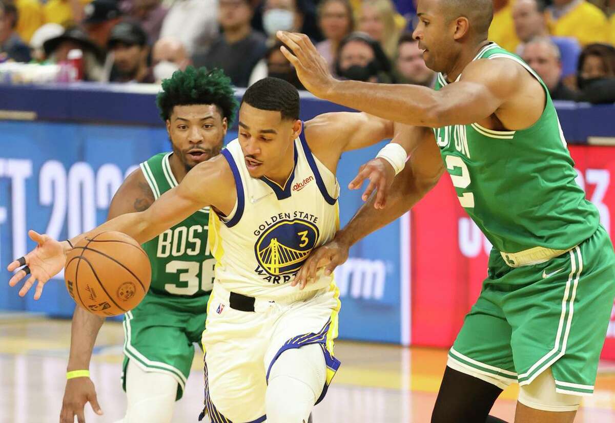 Golden State Warriors' Jordan Poole, 3, fights for the ball against Boston Celtics' Marcus Smart, 36, and Grant Williams, 12, during the second quarter of the NBA Finals at Chase Center in San Francisco, Calif., on Thursday, June 2, 2022.