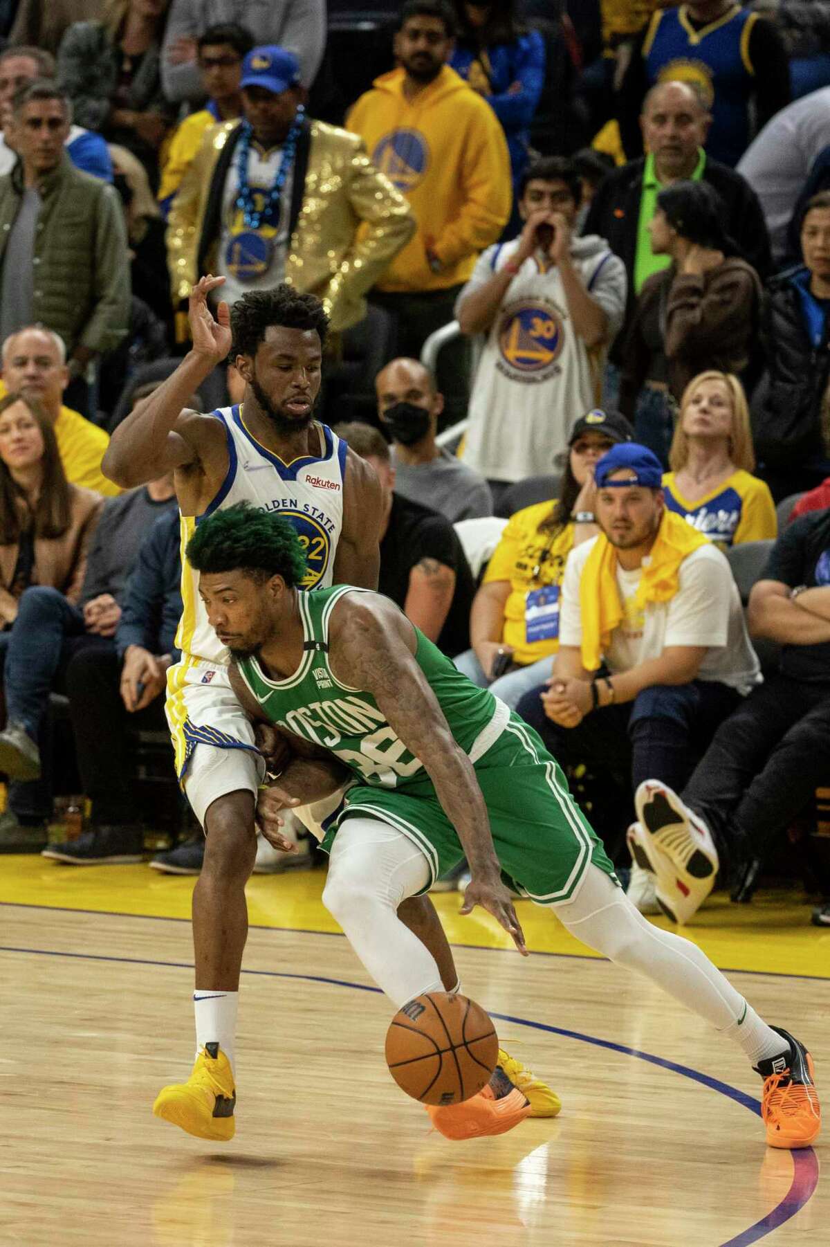 Boston Celtics' guard Marcus Smart drives towards the basket as Golden State Warriors' forward Andrew Wiggins defends during the fourth quarter in Game 1 of the NBA Finals at Chase Center in San Francisco, Calif. Thursday, June 2, 2022. The Celtics defeated the Warriors 120-108.