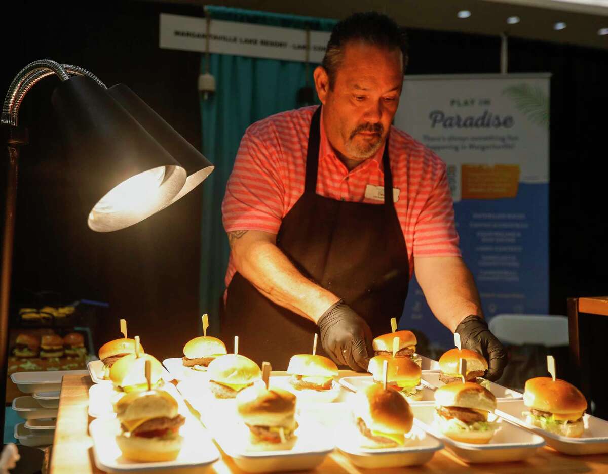 Chef David Cardoso with Margaritaville Lake Resort in Montgomery helps place cheeseburger sliders during the Conroe Chamber of Commerce’s annual Tastefest at the Lone Star Convention & Expo Center, Thursday, June 2, 2022, in Conroe. Five hundred guest enjoyed food at the hybrid event, where guest used their pass to enjoy the in-person event, as well as the ability to use it to dine at participating restaurants through the month of June.
