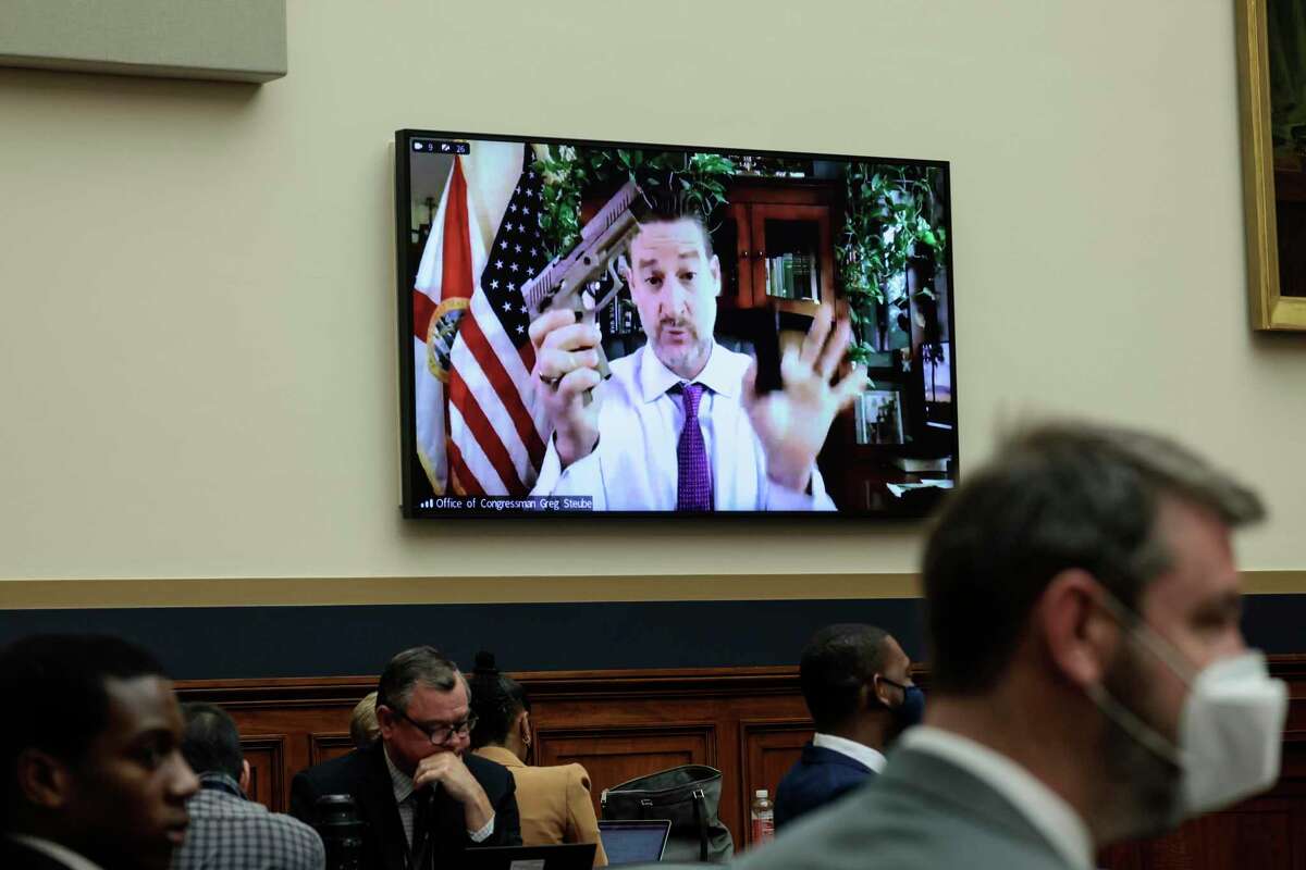 Rep. Greg Steube, R-Fla., demonstrates assembling his handgun as he speaks remotely during the committee hearing.
