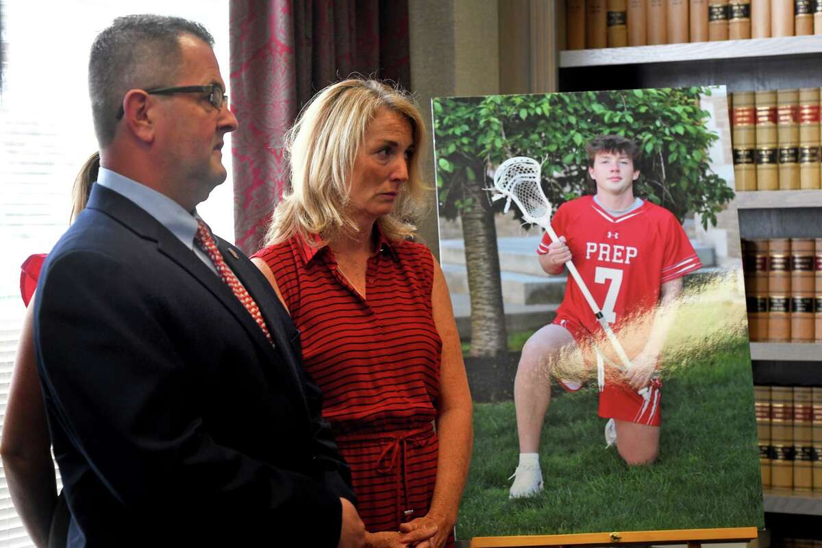 Kevin and Margaret McGrath, the parents of James McGrath, stand next to a poster of their son prior to a news conference in Bridgeport, Conn. June 3, 2022. James McGrath, 17, a Fairfield Prep student from Shelton was stabbed and killed during a house party in Shelton in May.