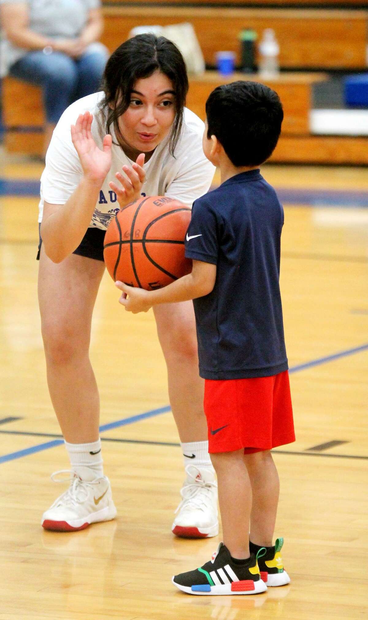 Former St. Augustine basketball player Vanessa Martinez coaches up a youngster on how to shoot during the Knights’ basketball camp which ran Wednesday and Thursday of this week.