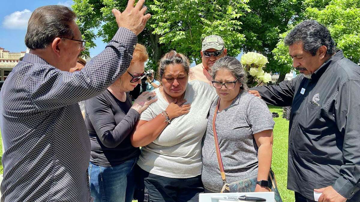 Mercedes Salas, center, a Robb Elementary fourth grade teacher, visited the makeshift memorial at Uvalde’s town square and cried for her students, whom she called her babies.