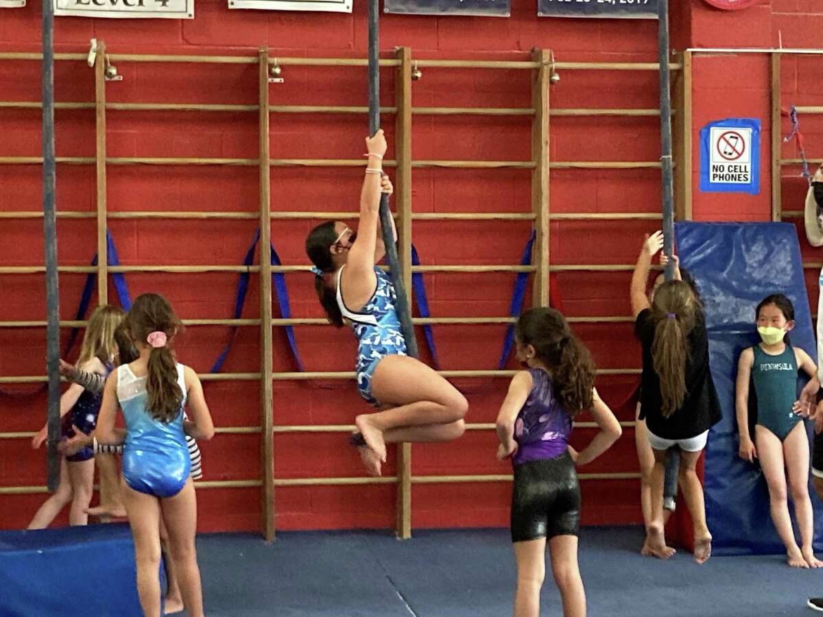 Shyne Staples, 10, exercises on a rope at Peninsula Gymnastics in San Mateo.