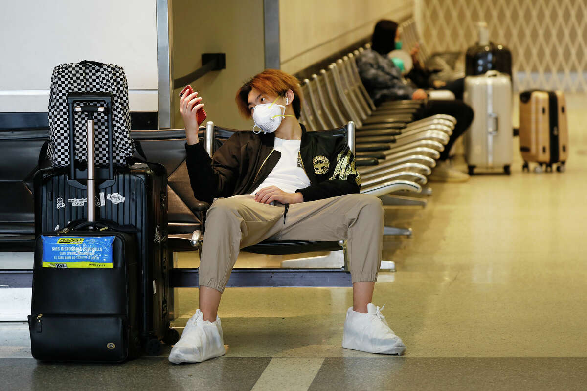 Tian Long waits for his flight back home to China at Tom Bradley International Terminal, LAX.