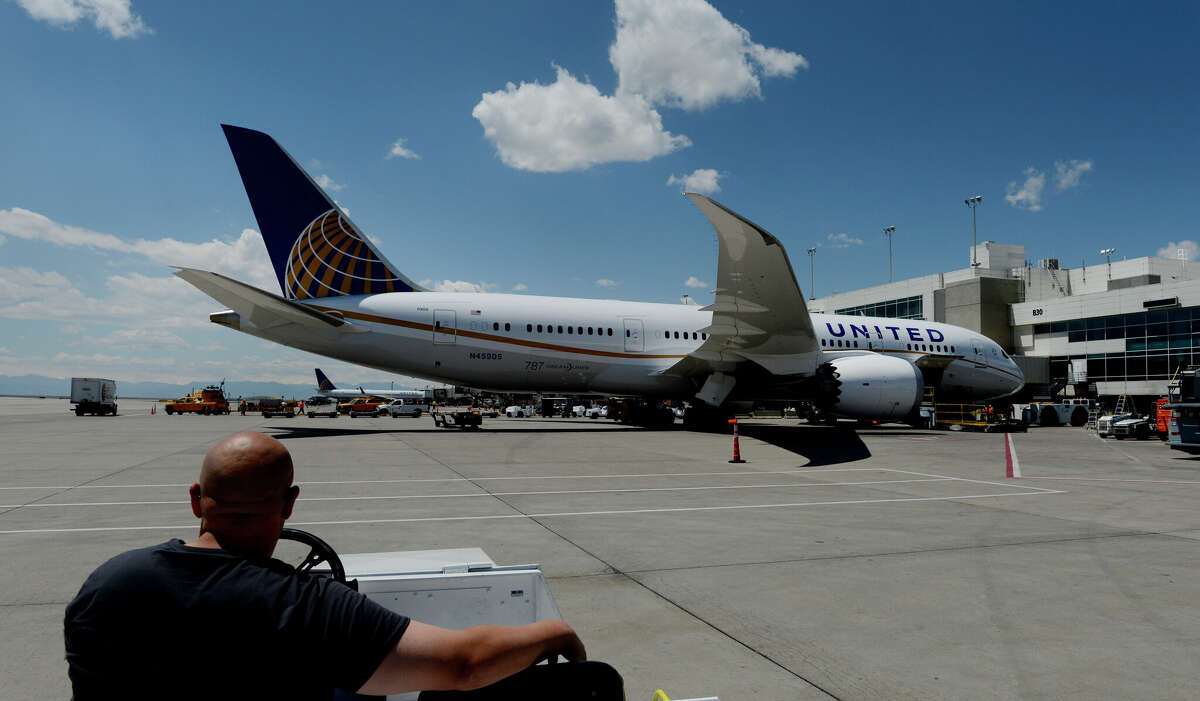 United ramp agent Jeff Larimer admires a Boeing 787 Dreamliner preparing for departure in May 2013.