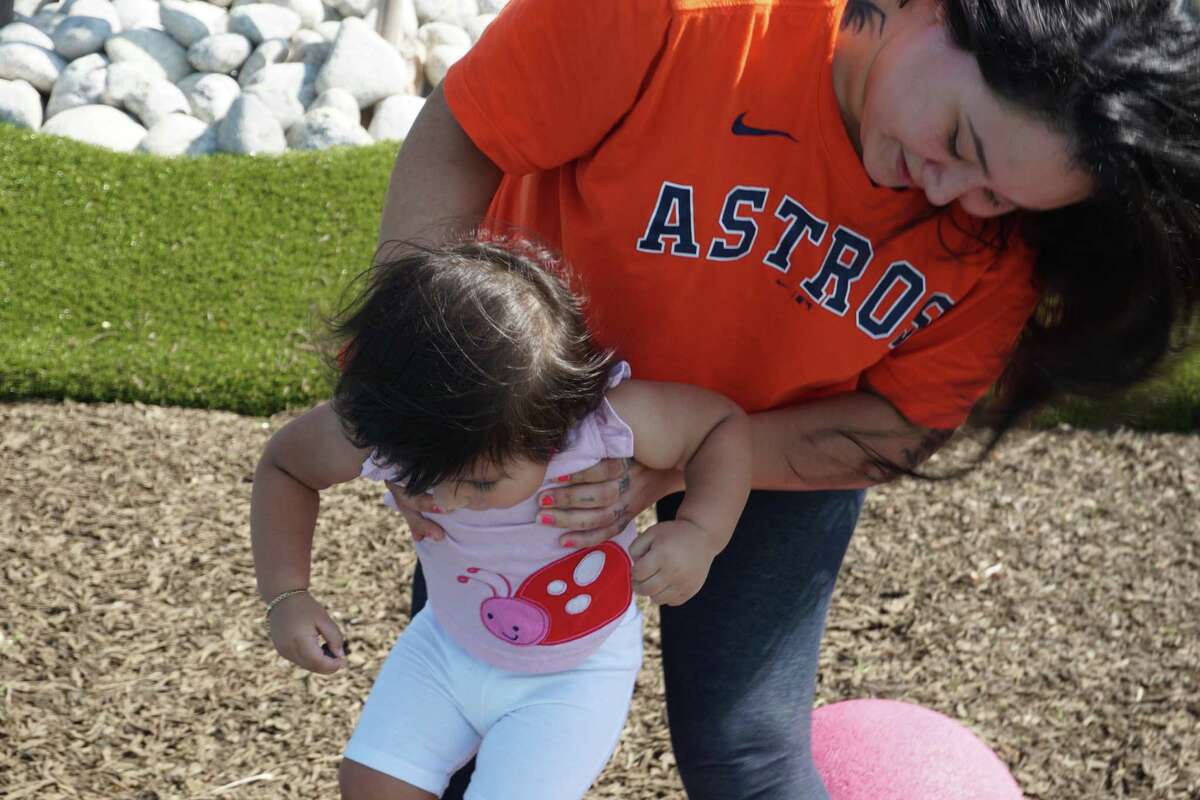 Krystal Barajas and her daughter, Melodie, play at Woodchase Park in Houston on Sunday, May 22.