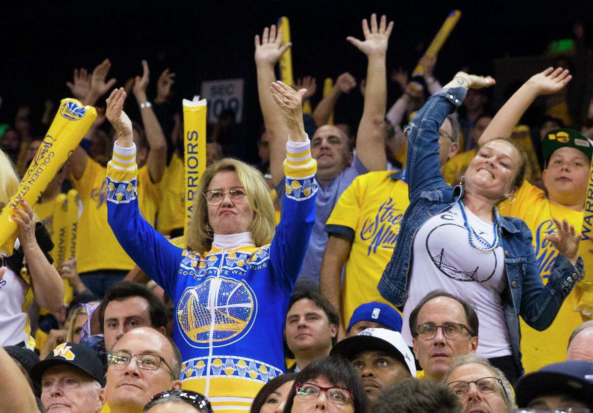 Robin Schreiber, also known as Sweater Mom, dances in the crowd as the Golden State Warriors take on the San Antonio Spurs during the fifth game of the NBA Playoffs Round 1 at Oracle Arena in 2018.