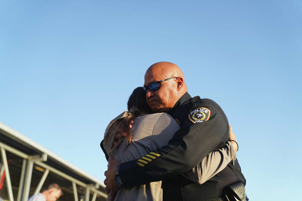 Uvalde Schools Police Chief Pedro “Pete” Arredondo comforts a woman during a vigil for the victims of the mass shooting at Robb Elementary School in Uvalde