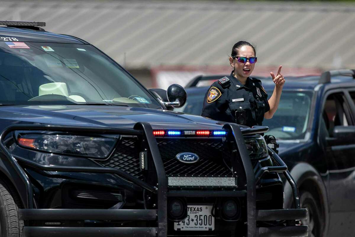A Fort Worth Police officer directs traffic after the funeral of Jacklyn Jalyen Cazares at Sacred Heart Catholic Church in Uvalde, TX on June 3, 2022.