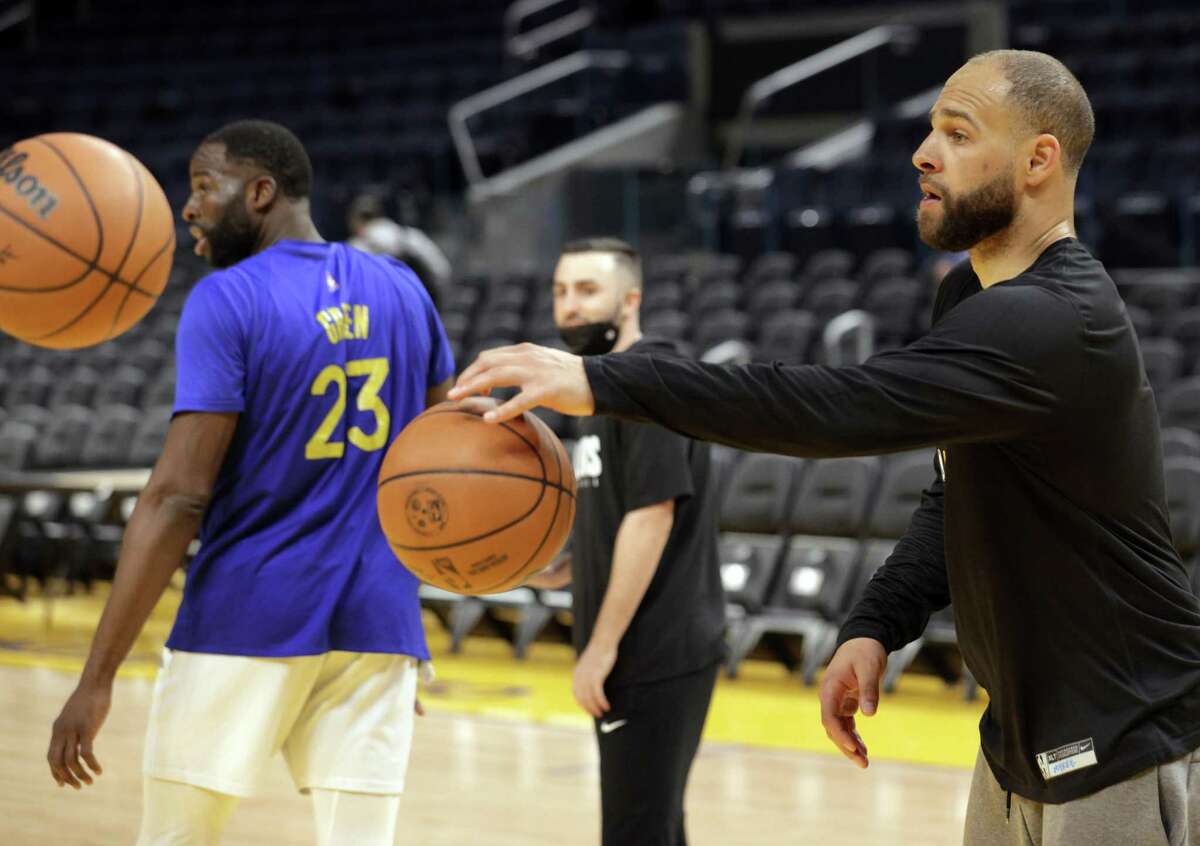 Mychel Thompson, right, works with Draymond Green, left, as the Golden State Warriors practiced before the NBA Finals get underway later in the week at Chase Center in San Francisco, Calif., on Monday, May 30, 2022.