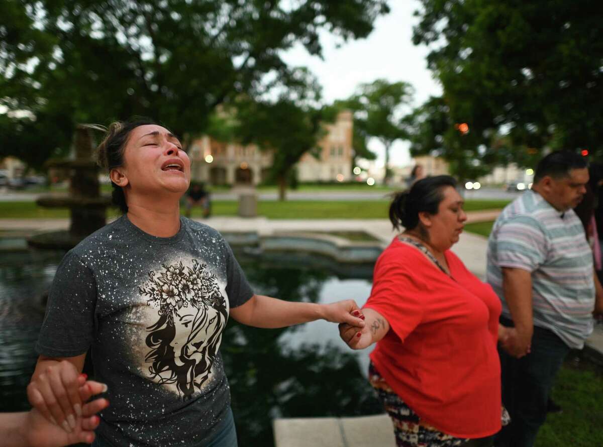 Kladys Castellón prays during a vigil for the 18 children and three adults that died at a mass shooting at Robb Elementary School in Uvalde on Tuesday, May 24, 2022.