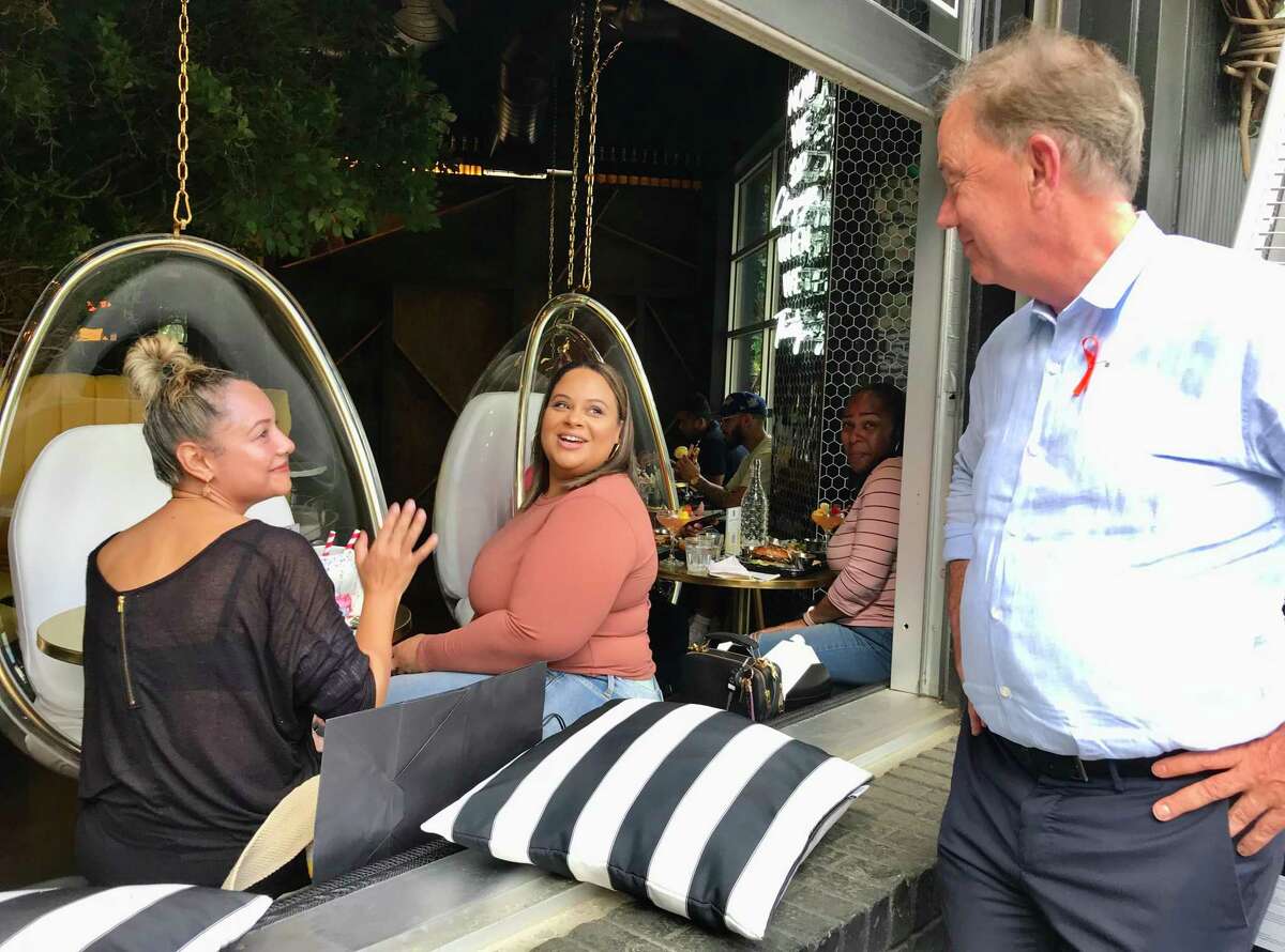 Gov. Ned Lamont joked Friday afternoon with two customers at The Place 2 Be restaurant in West Hartford. Sandra Cohen, left, from Berlin, said she was a supporter. Sandra Rivera is from Rhode Island.