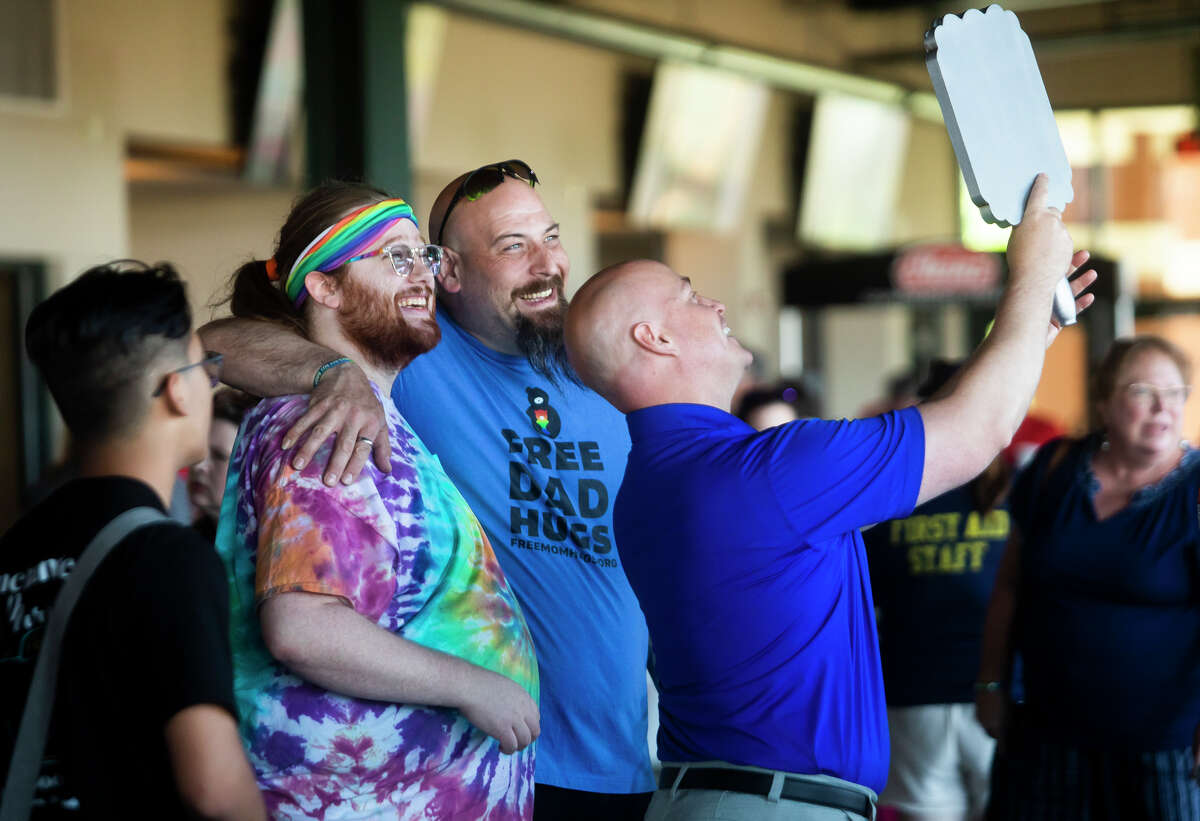 Lucas McClymont, left, and Vincent Reale, center, take a selfie with Jeffrey Henning of Nightlife Entertainment, right, during a game between the Great Lakes Loons and the Fort Wayne Tincaps on Pride Night, Friday, June 3, 2022 at Dow Diamond.