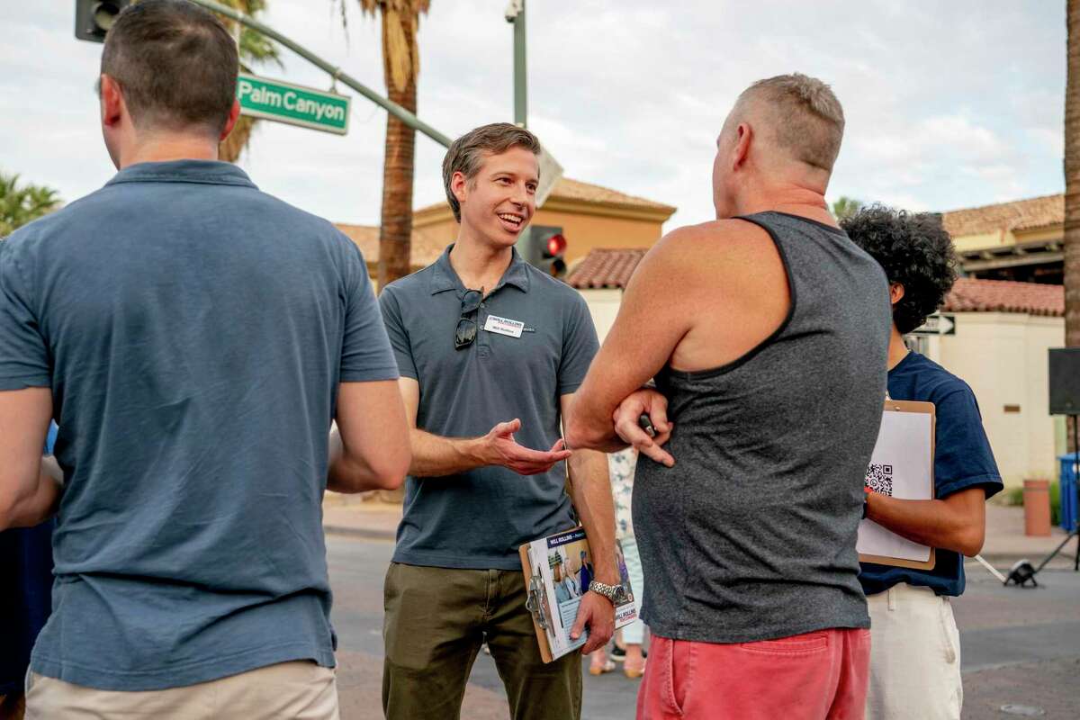 Rollins canvasses with supporters in Palm Springs as part of his House campaign.
