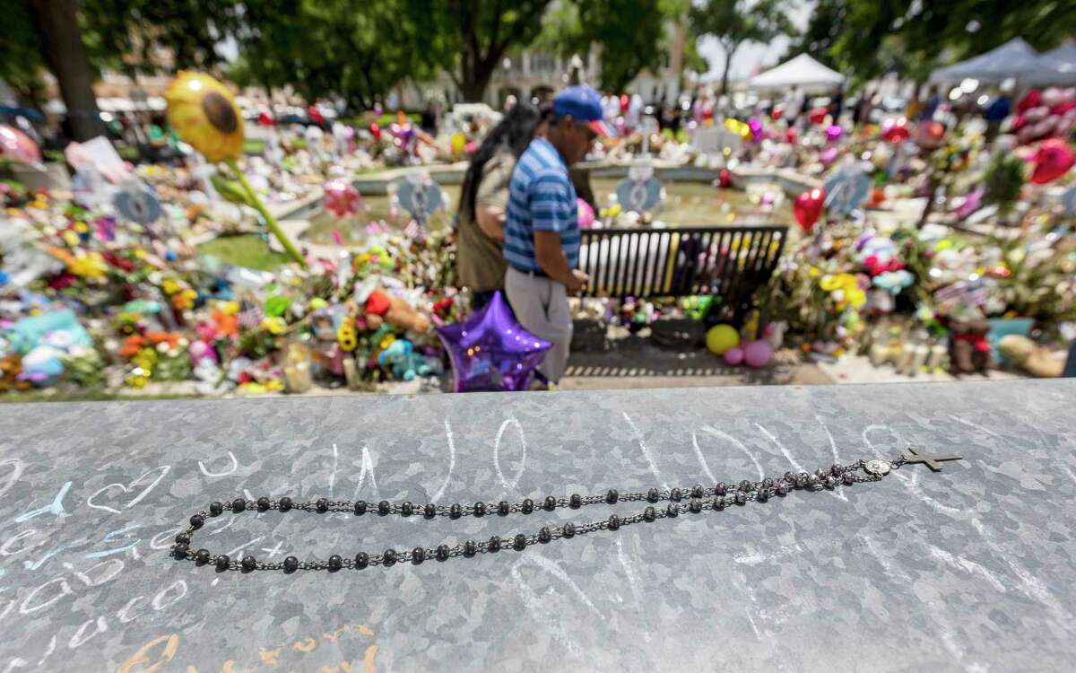 A rosary lies Tuesday, May 31, 2022 near memorials in Uvalde’s town square for 19 children and two adults killed at Robb Elementary School May 24, 2022 by a gunman with an assault rifle.