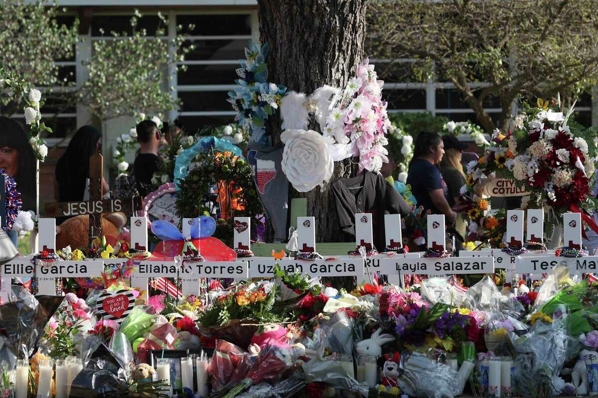 People line up to pay their respects at a memorial at Robb Elementary School, in Uvalde, Texas, Sunday, May 29, 2022. On Tuesday, 21 people, including 19 students, were killed in a mass shooting.
