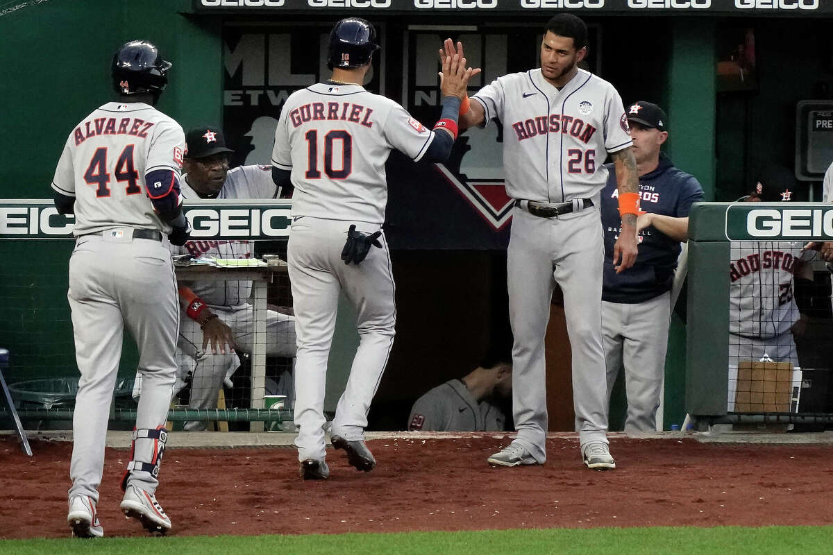 Houston Astros' Yuli Gurriel (10) celebrates with Jose Siri (26) after scoring on a two-run home run hit by Yordan Alvarez (44) during the fifth inning of a baseball game against the Kansas City Royals Friday, June 3, 2022, in Kansas City, Mo. (AP Photo/Charlie Riedel)