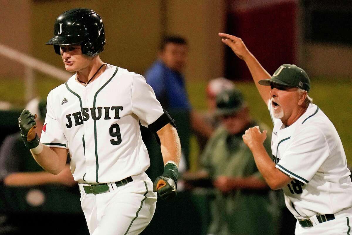 Strake Jesuit's Trey Duffield (9) celebrates his game-tying solo home run with head coach Raul Garcia-Rameau during the sixth inning of Game 2 of the Region III-6A Championship high school baseball playoff series against Ridge Point, Friday, June 3, 2022, in Houston.
