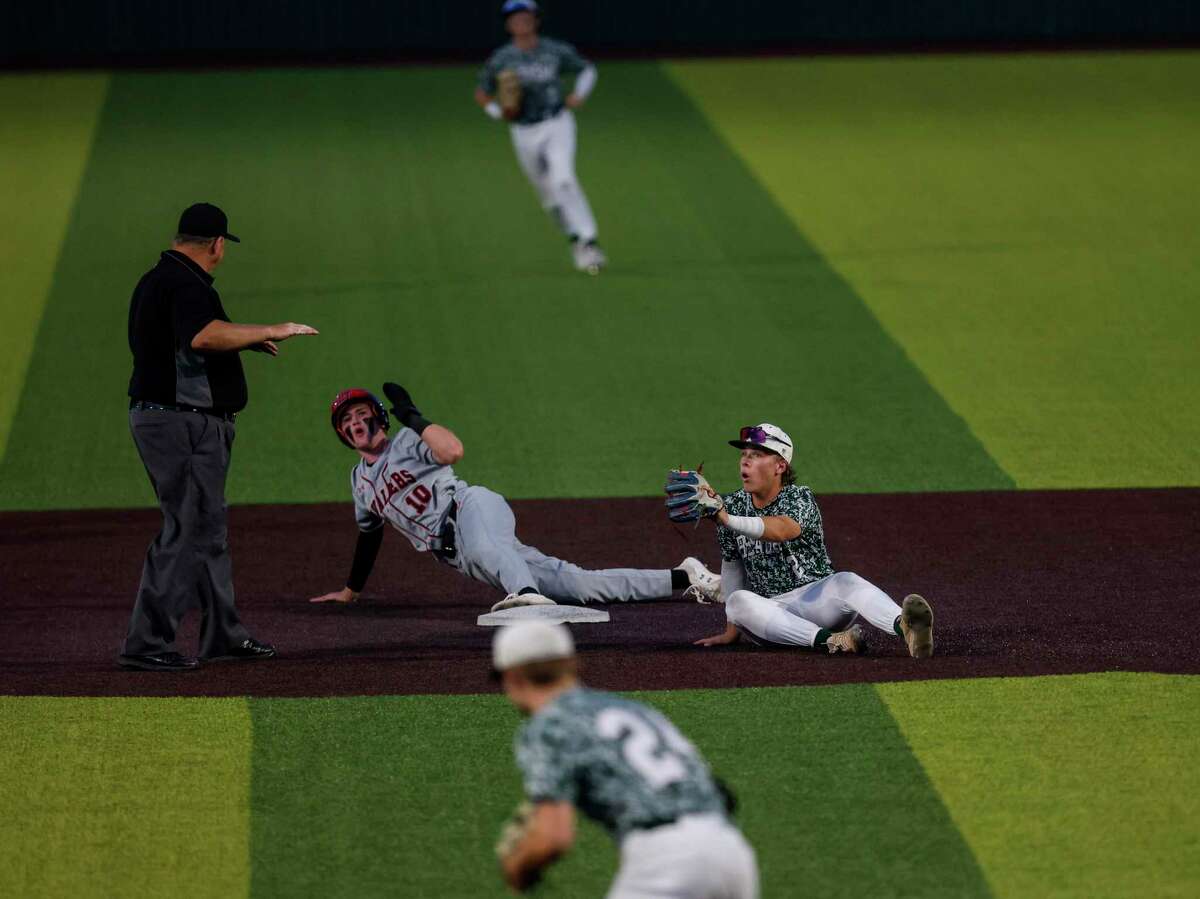 Reagan's Cole Tabor (2) reacts as Lake Travis's Richards Liam (10) is ruled safe at second base during the fifth inning of the first game of a best of three Region IV-6A final series at North East Sports Park in San Antonio, TX, Monday, Sept. 20, 2021. The Rattlers took a 1-0 lead in the best of three series by defeating the Cavaliers 3-2 in nine innings.