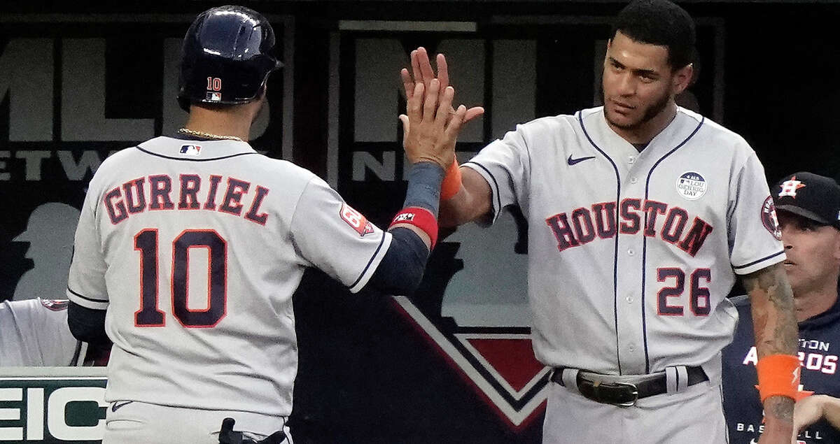 Houston Astros' Yuli Gurriel (10) celebrates with Jose Siri (26) after scoring on a two-run home run hit by Yordan Alvarez (44) during the fifth inning of a baseball game against the Kansas City Royals Friday, June 3, 2022, in Kansas City, Mo. (AP Photo/Charlie Riedel)