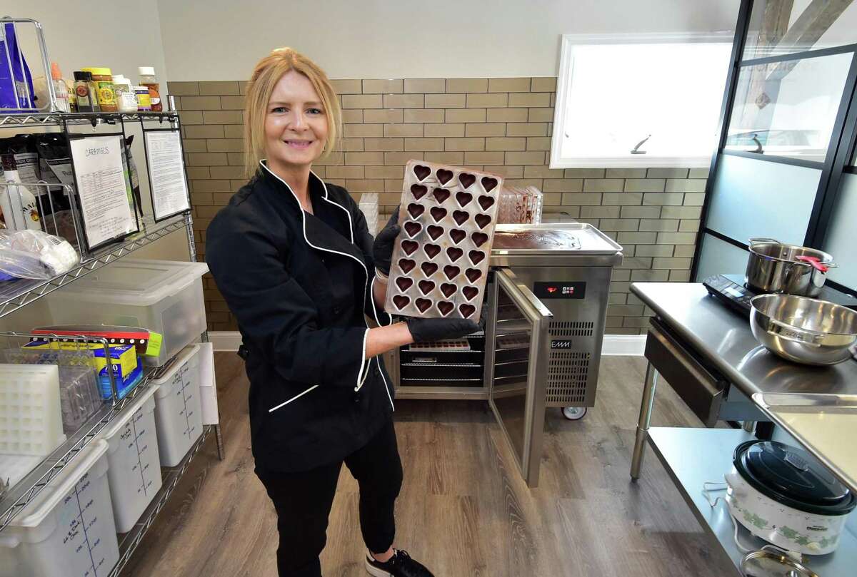 Laureen Haynes, owner of Chocolatierre, poses during one of her production days at the shop in Westport, Conn., on Tuesday May 31, 2022. After a career in the health care industry, Haynes recently opened the new chocolate shop on Church Lane.